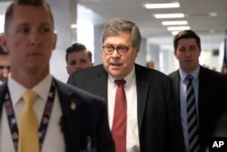 FILE - Since confirmed Attorney General nominee William Barr arrives for a meeting on Capitol Hill in Washington, Jan. 26, 2019. Barr pledged to provide “as much transparency as I can” on the Mueller report but declined to commit to releasing the report in its entirety.
