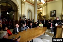FILE - Judd Choate, right, state election director for Colorado and president of the National Association of State Election Directors, addresses Colorado Electoral College electors at the State Capitol in Denver, Dec. 19, 2016.
