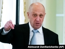 RUSSIA -- Businessman Yevgeny Prigozhin, left, gestures on the sidelines of a summit meeting between Russian President and Turkish President at the Konstantin palace outside St. Petersburg, August 9, 2016.