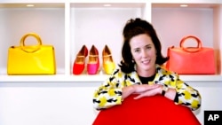 FILE - In this May 13, 2004 file photo, designer Kate Spade poses with handbags and shoes from her next collection in New York.