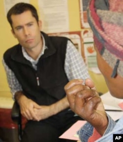 Zithulele Hospital’s chief doctor, Ben Gaunt, listens to an HIV-infected patient. He says allied health professionals aren’t getting the credit they deserve as South Africa battles HIV and AIDS