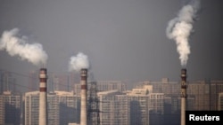 Smoking chimneys near residential buildings in Tianjin, China. Air pollution sometimes covers parts of the country at dangerous levels.