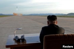 FILE - North Korean leader Kim Jong Un watches the launch of a Hwasong-12 missile in this undated photo released by North Korea's Korean Central News Agency.