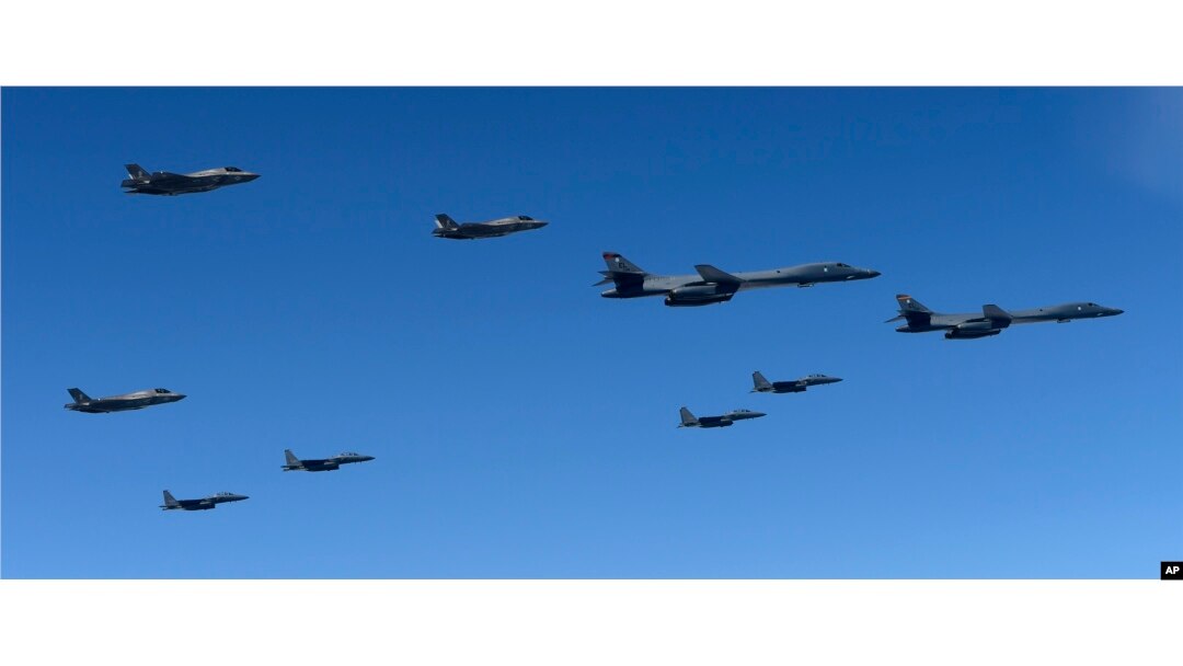 In this photo provided by South Korea Defense Ministry, U.S. Air Force B-1B bombers, F-35B stealth fighter jets and South Korean F-15K fighter jets fly over the Korean Peninsula during a joint drills, South Korea, Sept. 18, 2017.