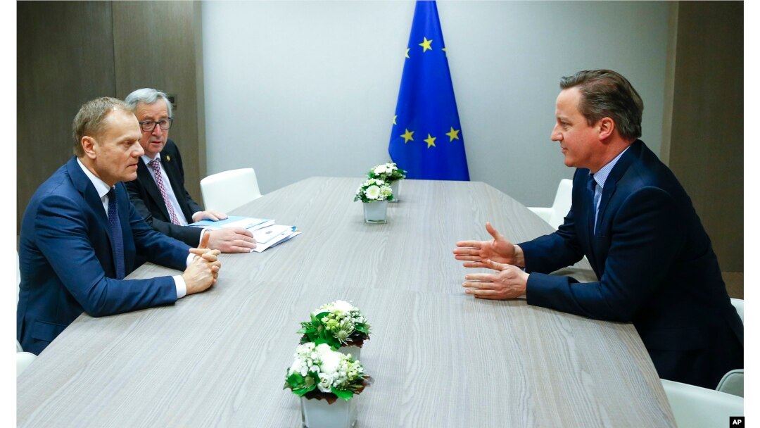 European Council President Donald Tusk, left, and European Commission President Jean-Claude Juncker, second left, participate in a meeting with British Prime Minister David Cameron during an EU summit in Brussels, Feb. 19, 2016.
