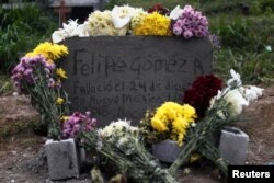 FILE - The grave of Felipe Gomez Alonzo, a 8-year-old boy who died in the custody of U.S. Customs and Border Protection after being detained along his father, is pictured during his funeral in Yalambojoch, Guatemala, Jan. 27, 2019.