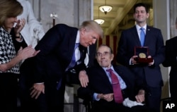 President Donald Trump speaks to former Sen. Bob Dole before House Speaker Paul Ryan of Wisconcin, right, presents him with the Congressional Gold Medal on Capitol Hill, Jan. 17, 2018, in Washington. Watching at left is Rep. Lynn Jenkins, R-Kansas.