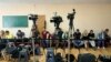 FILE - Journalists wait for President Volodymyr Zelenskiy's arrival at a polling station during parliamentary elections, in Kyiv, Ukraine, July 21, 2019. 