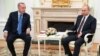 FILE - Turkey's President Recep Tayyip Erdogan, right, and Russia's President Vladimir Putin talk during a ceremony in Istanbul, Jan. 8, 2020.