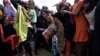 A Rohingya refugee reacts as people scuffle while waiting to receive aid in Cox's Bazar, Bangladesh, Sept. 26, 2017. 