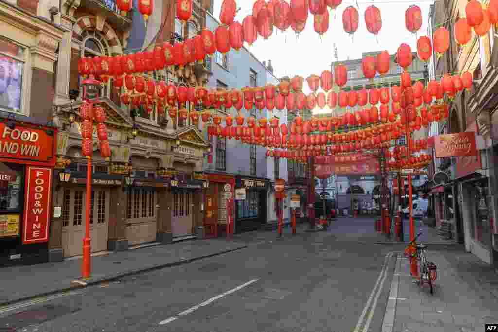 Pedestrians walk through the almost deserted streets of London's China Town district. As the deadly 2019-nCov strain of coronavirus has spread worldwide, it has carried with it xenophobia -- and Asian communities around the world are finding themselves subject to suspicion and fear.