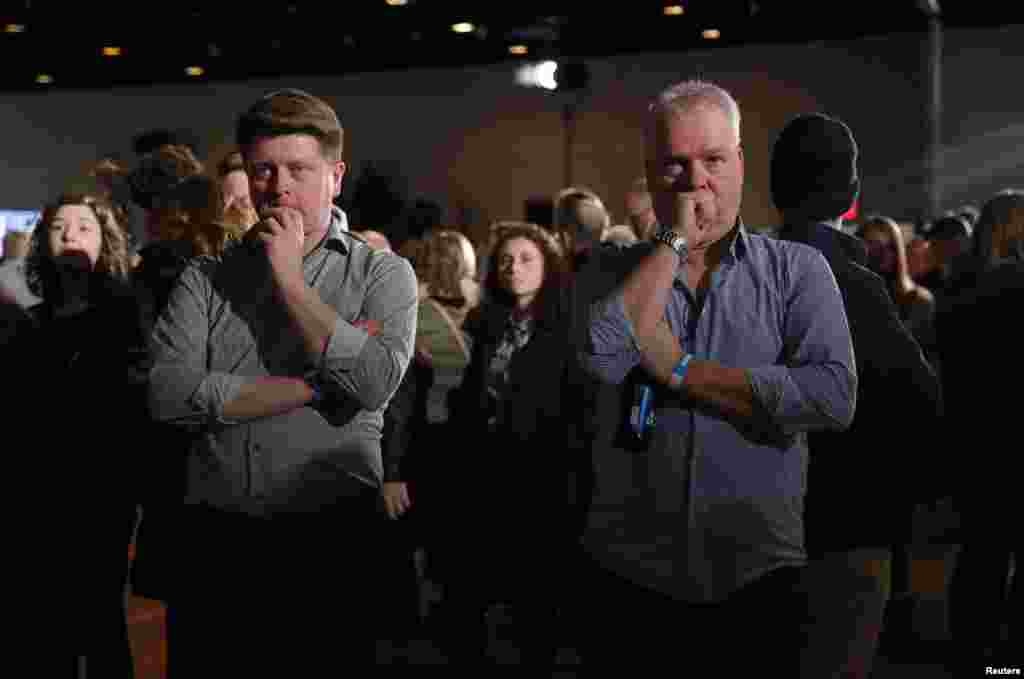 Supporters of Democratic presidential candidate former Vice President Joe Biden watch television results at his rally in Des Moines, Iowa, Feb. 3, 2020.