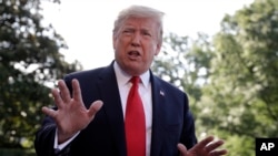 FILE - President Donald Trump talks with reporters before departing on Marine One for the Air Force Academy graduation ceremony, May 30, 2019, in Washington.
