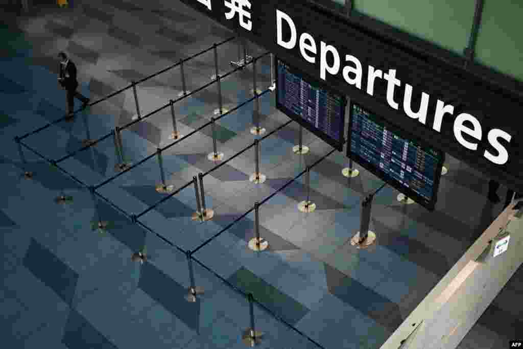 A man walks through a departure floor of the international terminal at Haneda airport in Tokyo.