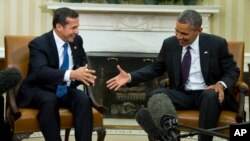 President Barack Obama reaches to shakes hands with with Peru's President Ollanta Humala in the Oval Office of the White House in Washington, June 11, 2013.