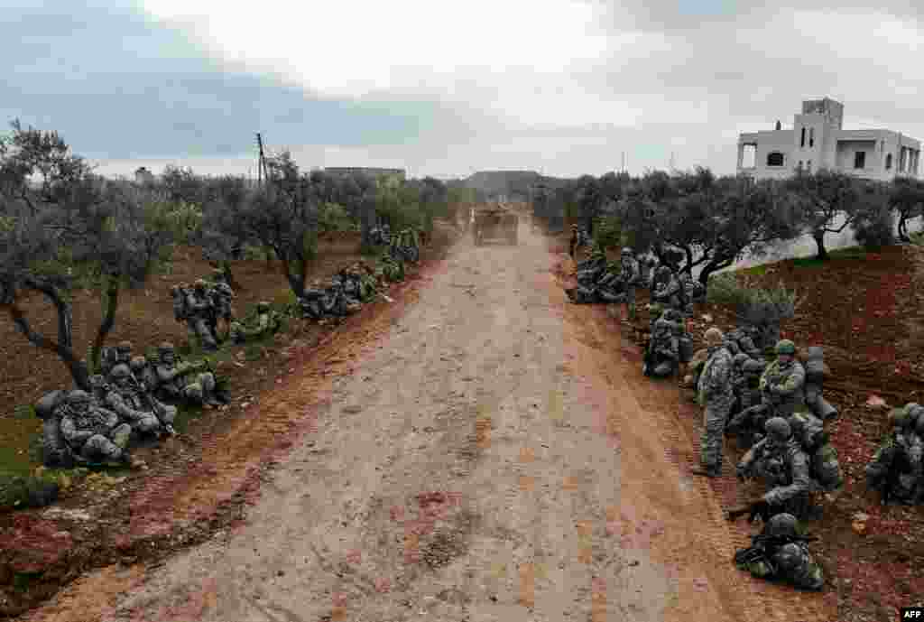 Turkish soldiers gather in the village of Qaminas, about 6 kilometres southeast of Idlib city in northwestern Syria.