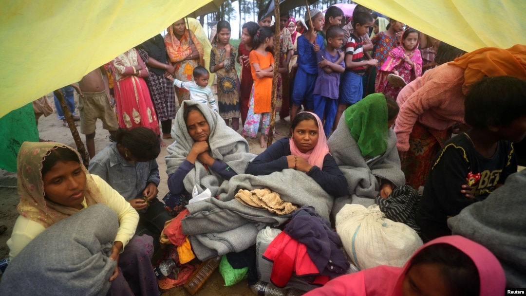 Rohingya refugees, who were on a boat traveling from Myanmar that capsized at Bailakhali beach, wait to transported to a refugee camp from the beach, near Cox's Bazar, Bangladesh, Oct. 31, 2017.