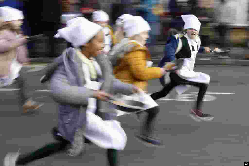 Schoolchildren from local schools take part in the children's races prior to the annual Pancake race in Olney, Buckinghamshire, England, United Kingdom.