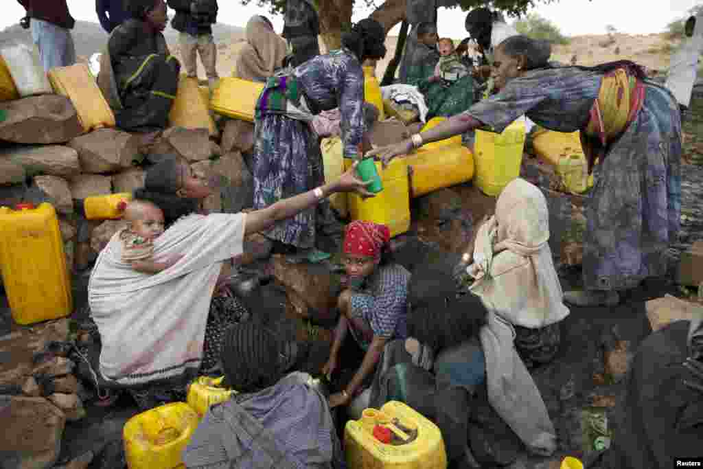 Women collect water from a stream outside the village of Tsemera in Ethiopia's northern Amhara region, February 13, 2016.