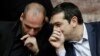 Greece's Prime Minister Alexis Tsipras chats with Greece's Finance Minister Yanis Varoufakis during a Presidential vote in Athens, on Wednesday, Feb. 18, 2015.