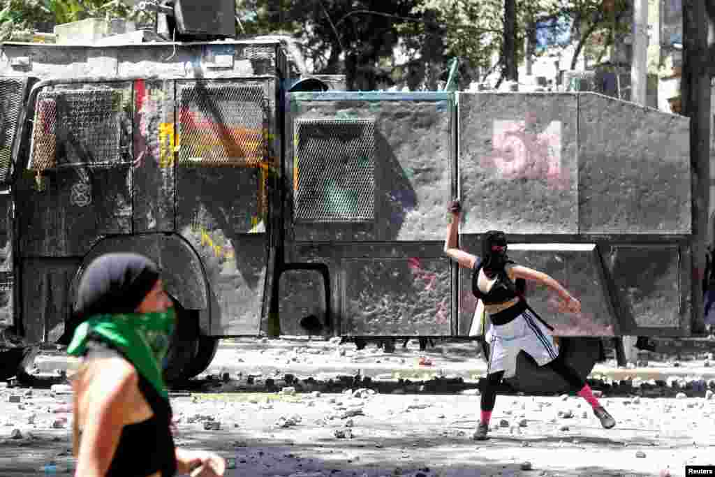 Women clash at a rally during the International Women's Day in Santiago, Chile, March 8, 2020.