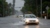 Los automóviles circulan por calles inundadas, el martes 11 de junio de 2024, en Surfside, Florida, EEUU.