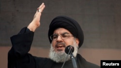 FILE - Lebanon's Hezbollah leader Sayyed Hassan Nasrallah addresses his supporters during a religious procession to mark Ashura in Beirut's suburbs, Nov. 14, 2013. 