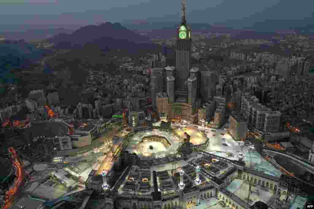 An aerial view of Saudi Arabia's holy city of Mecca, with the Abraj al-Bait Mecca Royal Clock Tower overlooking the Grand Mosque and Kaaba in the center, is seen during the early hours of Eid al-Fitr, the Muslim holiday which starts at the conclusion of the holy fasting month of Ramadan.