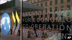 The logo at the entrance of the Organisation for Economic Co-operation and Development (OECD) headquarters in Paris, France, Wednesday, June 7, 2017. (AP Photo/Francois Mori)
