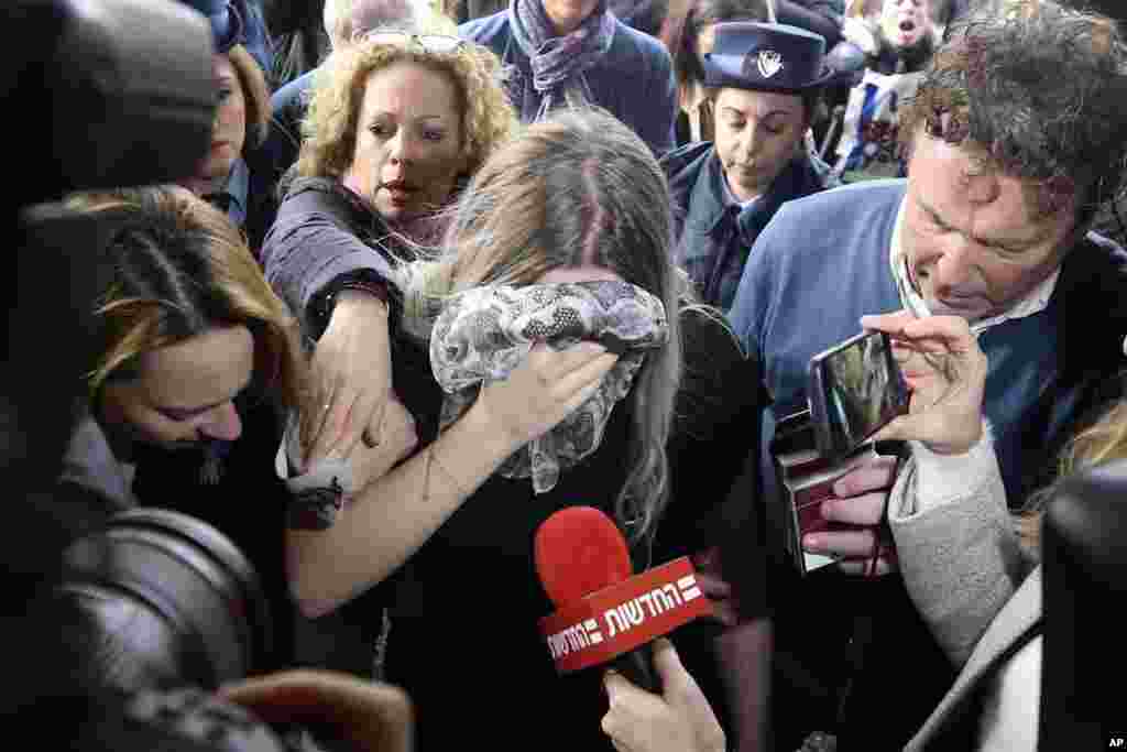 A 19 year-old British woman, center, who was found guilty of making up claims that she was raped by up to 12 Israelis, arrives at Famagusta District Court for sentencing in Paralimni, Cyprus.
