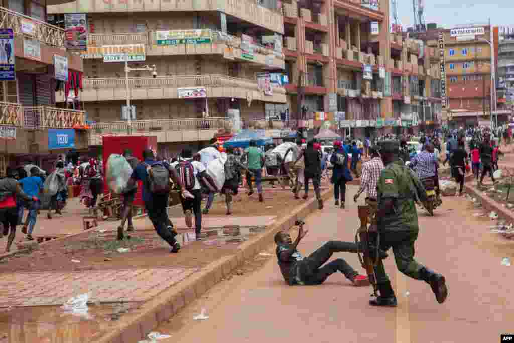 A police officer chases street vendors in Kampala, Uganda, after President Yoweri Museveni directed the public to stay home for 32 days starting to curb the spread of the coronavirus.