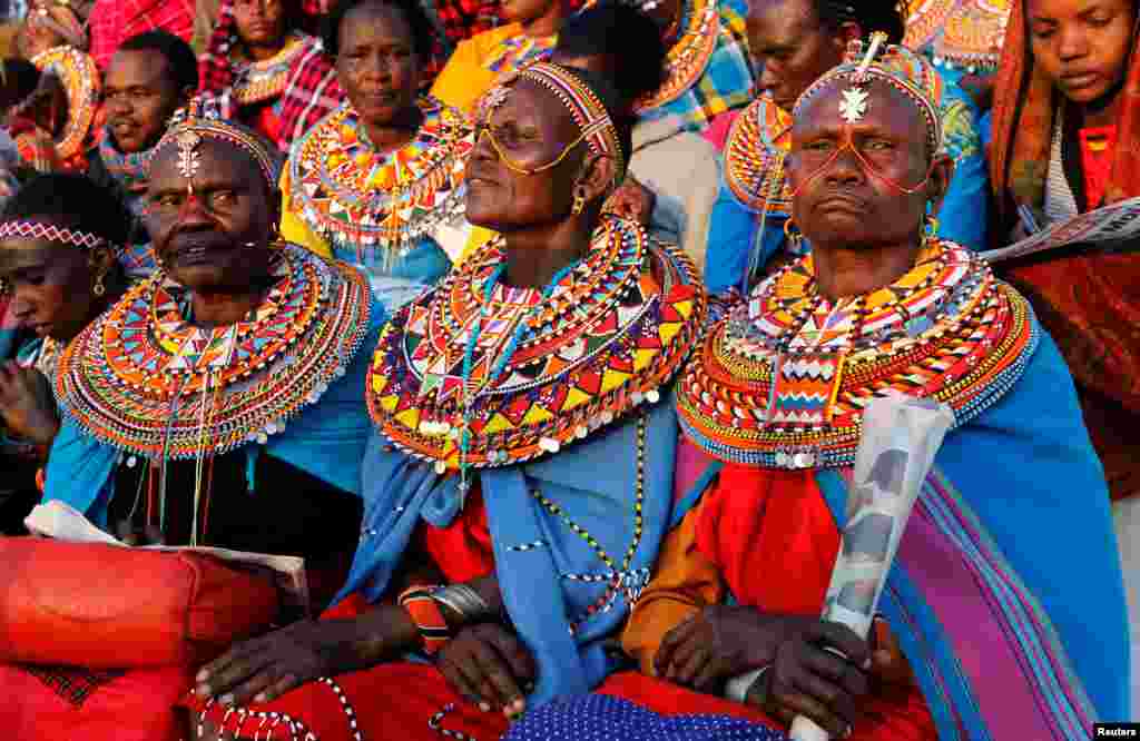 Maasai women dressed in traditional regalia attend a memorial service for late former Kenya's President Daniel Arap Moi at the Nyayo Stadium in Nairobi.