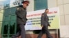 Police officers walk outside a polling station in Dushanbe November 1, 2013. Tajikistan's President Imomali Rakhmon is expected to win a new seven-year term in an election on Nov. 6, extending his rule in the former Soviet republic in Central Asia to near