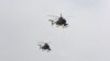 FILE - U.S.-made MD-530 helicopters, like the ones used by the Afghan Air Force, fly over Kabul, Afghanistan, Feb. 11, 2016. 