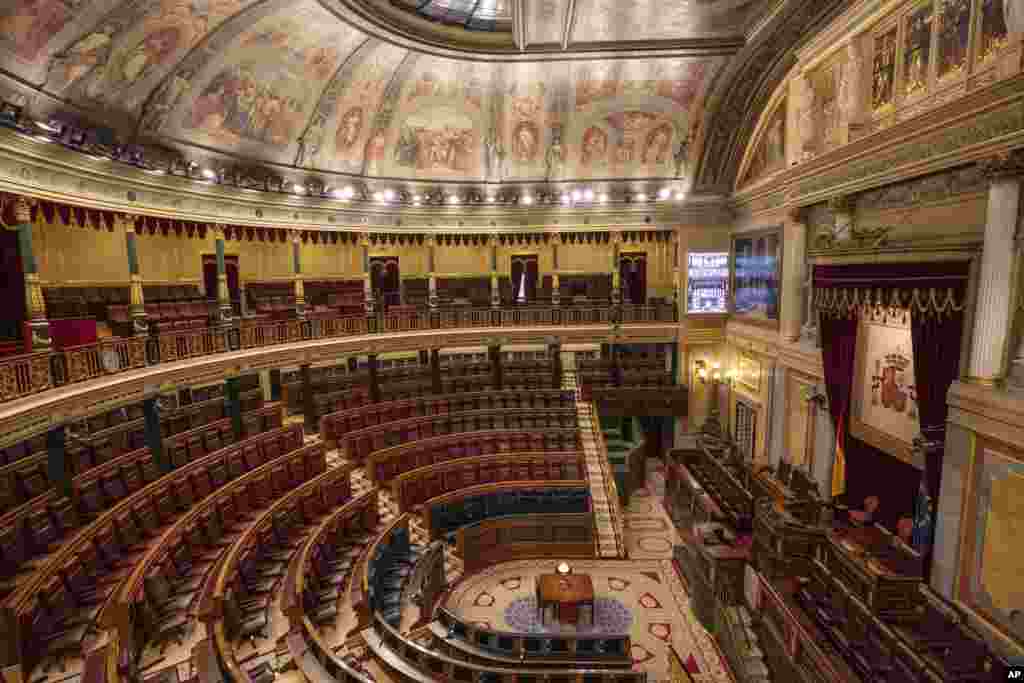 Empty seats of Spanish parliament's lower house in Madrid. The Spanish parliament's lower house has canceled its activities for a week after a prominent lawmaker from the upstart far-right Vox party tested positive for the COVID-19 disease.