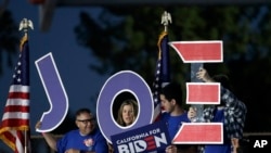 Supporters hold a sign before a campaign rally for Democratic presidential candidate former Vice President Joe Biden, March 3, 2020, in Los Angeles. 
