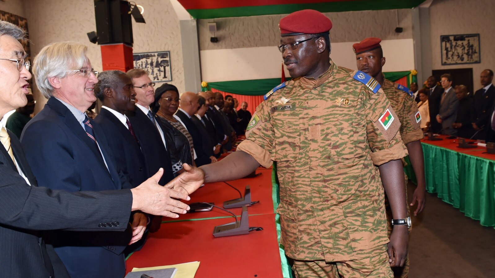 Lieutenant Colonel Isaac Zida, named by Burkina Faso's army as interim leader following the ousting of president Blaise Compaore,shakes hands with ambassadors during a meeting gathering soldiers and diplomats on Nov. 3, 2014 in Ouagadougou. 