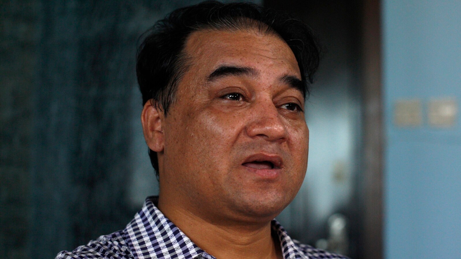 FILE - Outspoken Uighur scholar and advocate Ilham Tohti speaks during an interview at his home in Beijing.