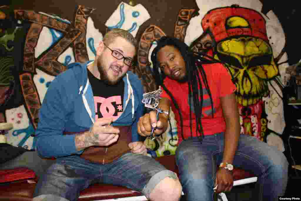 Dave Smith (left) and Tiplo Tsotetsi are the owner-artists at Black and White Tattoos, a popular parlor in Johannesburg’s Rosebank district that scribes original work on men and women. (Photo by Darren Taylor)