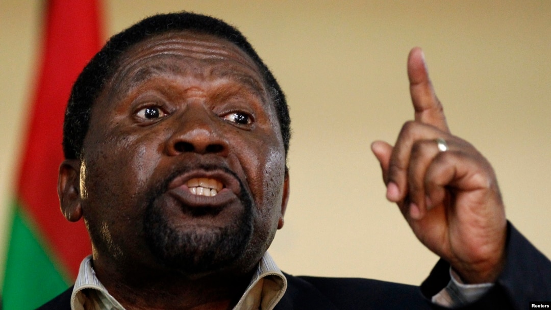 FILE - Isaias Samakuva, leader of Angola's main opposition UNITA party, addresses supporters at a rally in Viana, east of Luanda, Aug. 29, 2012. 