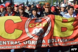 El presidente de Bolivia, Luis Arce (C-R) y su vicepresidente David Choquehuanca (C-L), participan en una marcha de la Unión de Trabajadores de Bolivia (COB) para conmemorar el Día Internacional del Trabajo en Cochabamba, Bolivia, el 1 de mayo de 2024.