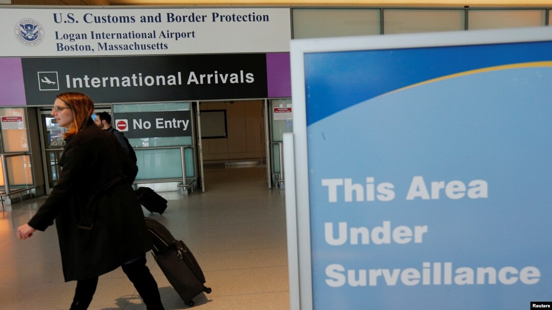 FILE - International travelers arrive at Logan Airport following a federal court's temporary stay of U.S. President Donald Trump's executive order travel ban in Boston, Massachusetts.