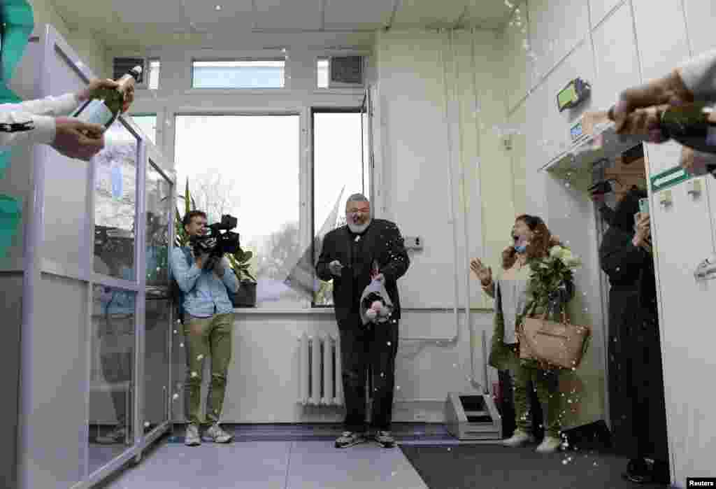 Russian investigative newspaper Novaya Gazeta's editor-in-chief Dmitry Muratov, one of 2021 Nobel Peace Prize winners, is greeted with champagne by editorial staff in Moscow, Russia.