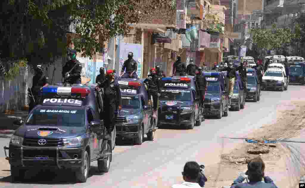 Police vehicles patrol during a government-imposed nationwide lockdown to contain the coronavirus, in Hyderabad, Pakistan.