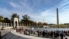 Friends, family, and guests greet World War II veterans following a Veterans Day ceremony at the World War II Memorial in Washington, Nov. 11, 2021.