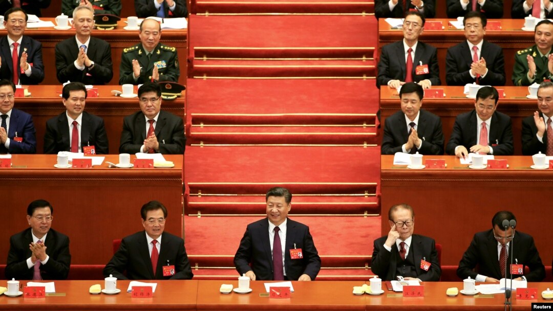 FILE - Chinese President Xi Jinping, center, attends the opening of the 19th National Congress of the Communist Party of China at the Great Hall of the People in Beijing, China, Oct. 18, 2017.