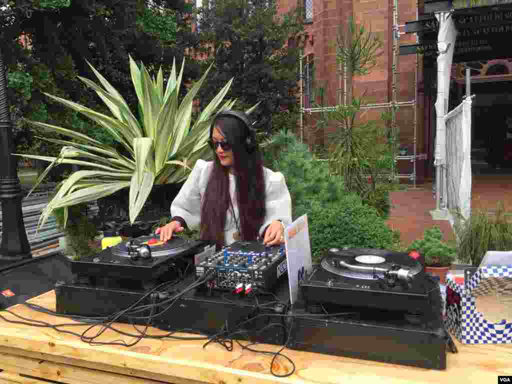 A house DJ plays music for the guests in the Enid A. Haupt Garden. (Y. Jung/VOA)