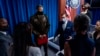 FILE - Pentagon spokesperson John Kirby, center right, speak to reporters as they depart a briefing at the Pentagon, near Washington, Aug. 25, 2021. 