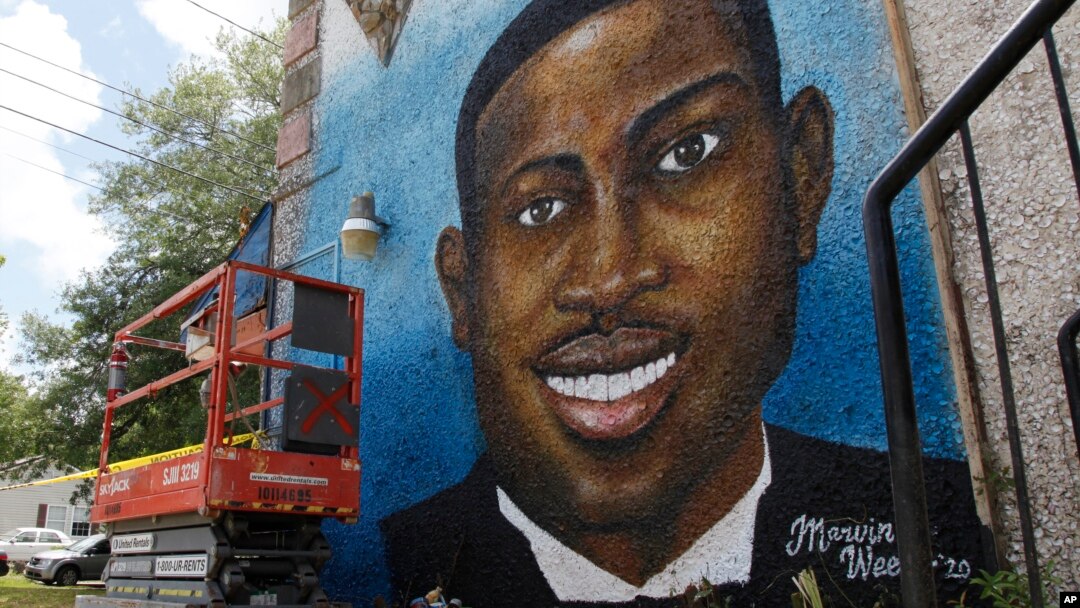 FILE - This May 17, 2020, photo shows a mural depicting Ahmaud Arbery in Brunswick, Ga.