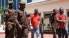 Tanzania's main opposition Chadema party leader Freeman Mbowe (center, in red shirt) arrives at the High Court in Dar es Salaam, Tanzania, Feb. 18, 2022.